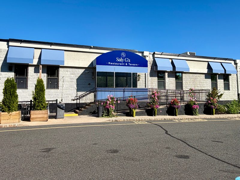 Saly G's Restaurant & Tavern with blue storefront and window awnings by SV Design